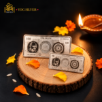 OG SILVER premium 100g and 10g fine silver bars displayed with a festive Diya and marigold petals.