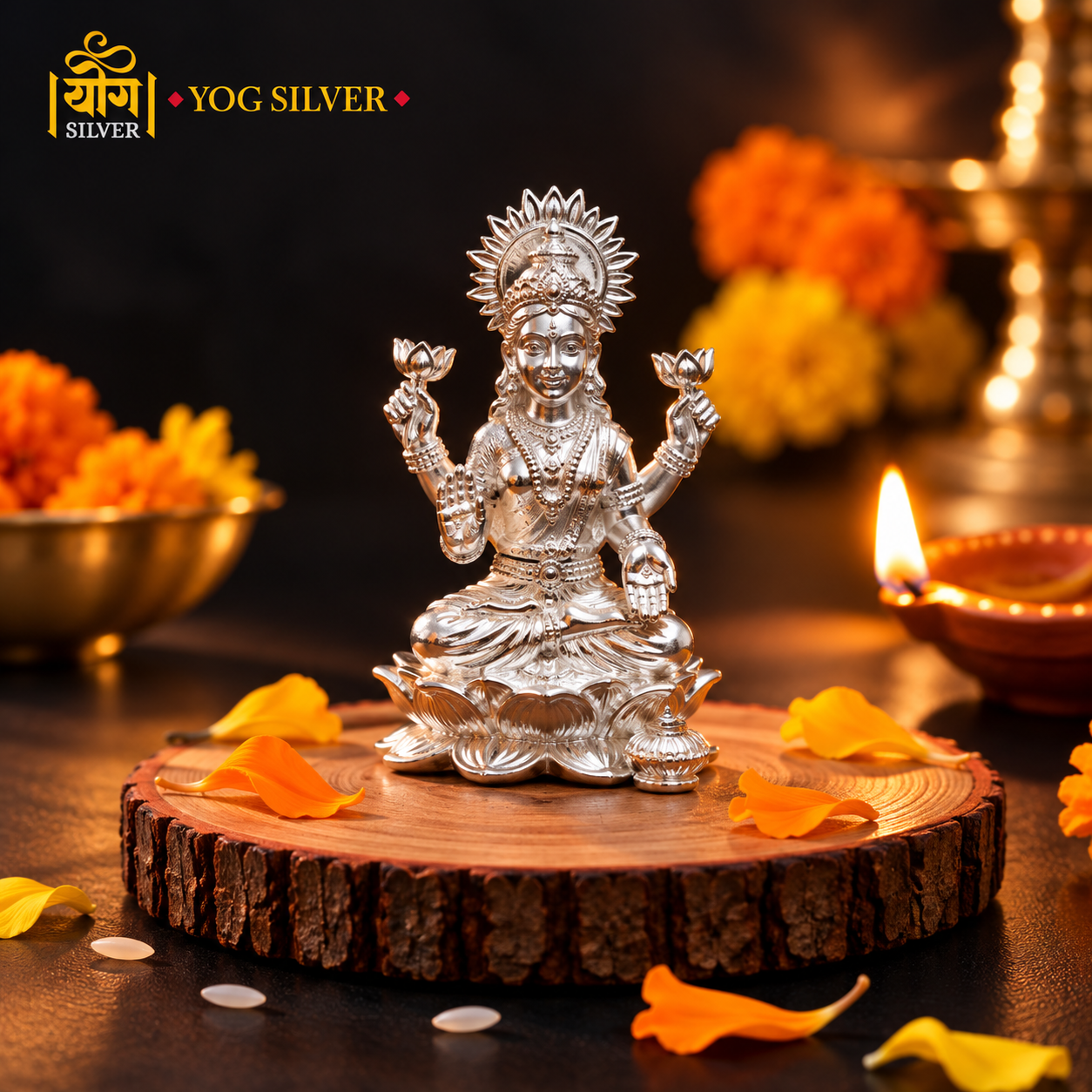 YOG SILVER Lakshmi silver idol with intricate traditional detailing displayed on a wooden platform with festive diyas and marigold flowers.